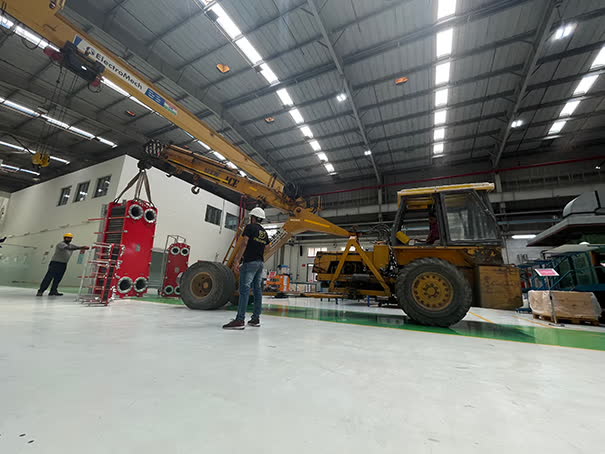 Shooting in a manufacturing hall with a yellow overhead crane