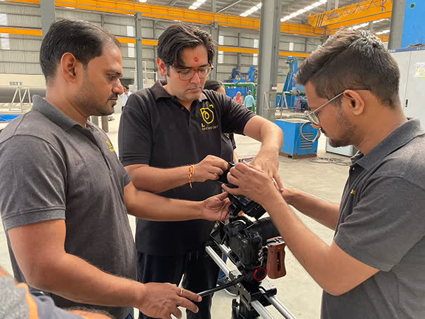Crew rigging a camera on a slider inside a plant